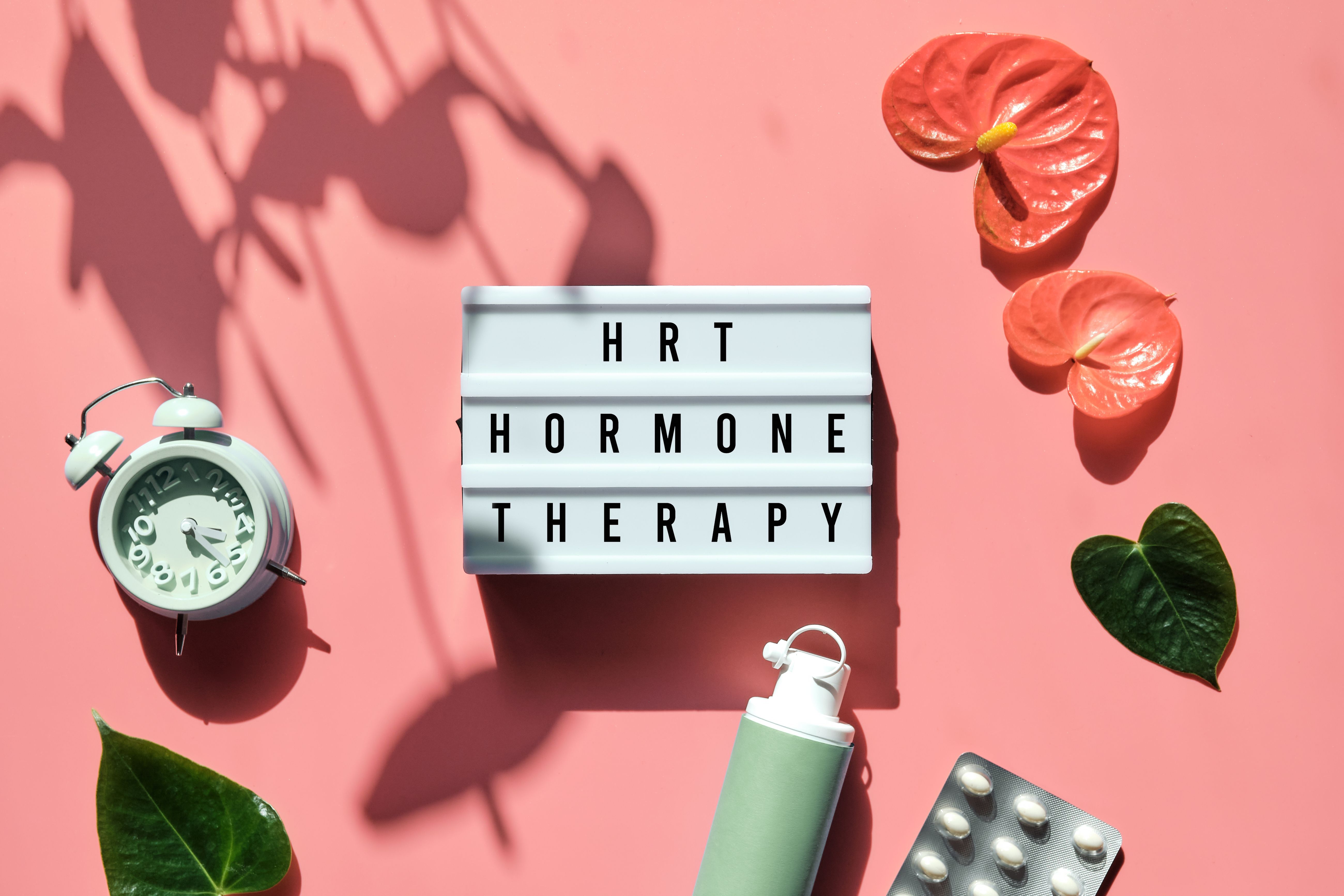 HRT Hormone Therapy sign surrounded by plants and hormone therapy pills | Image Credit: © tilialucida - stock.adobe.com