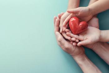 Family hands holding red heart, heart health insurance, charity volunteer donation, CSR responsibility, world heart day, world health day, family day, adoption foster care home, compliment concept - Image credit: SewcreamStudio | stock.adobe.com