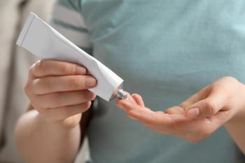 Woman applying topical gel