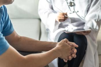 Male patient receiving consultation from health care professional -- Image credit: Chinnapong | stock.adobe.com