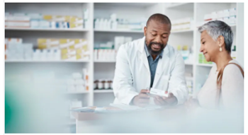 A pharmacist showing a patient her medication.
