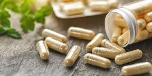 Capsules of nutritional supplements and vitamins support better gut health. There is an exploration of probiotics in capsule format, next to an unmarked open package. - Image credit: Rasim | stock.adobe.com