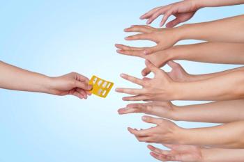 Hands reaching for pack of pills | Image Credit: © San7news - stock.adobe.com