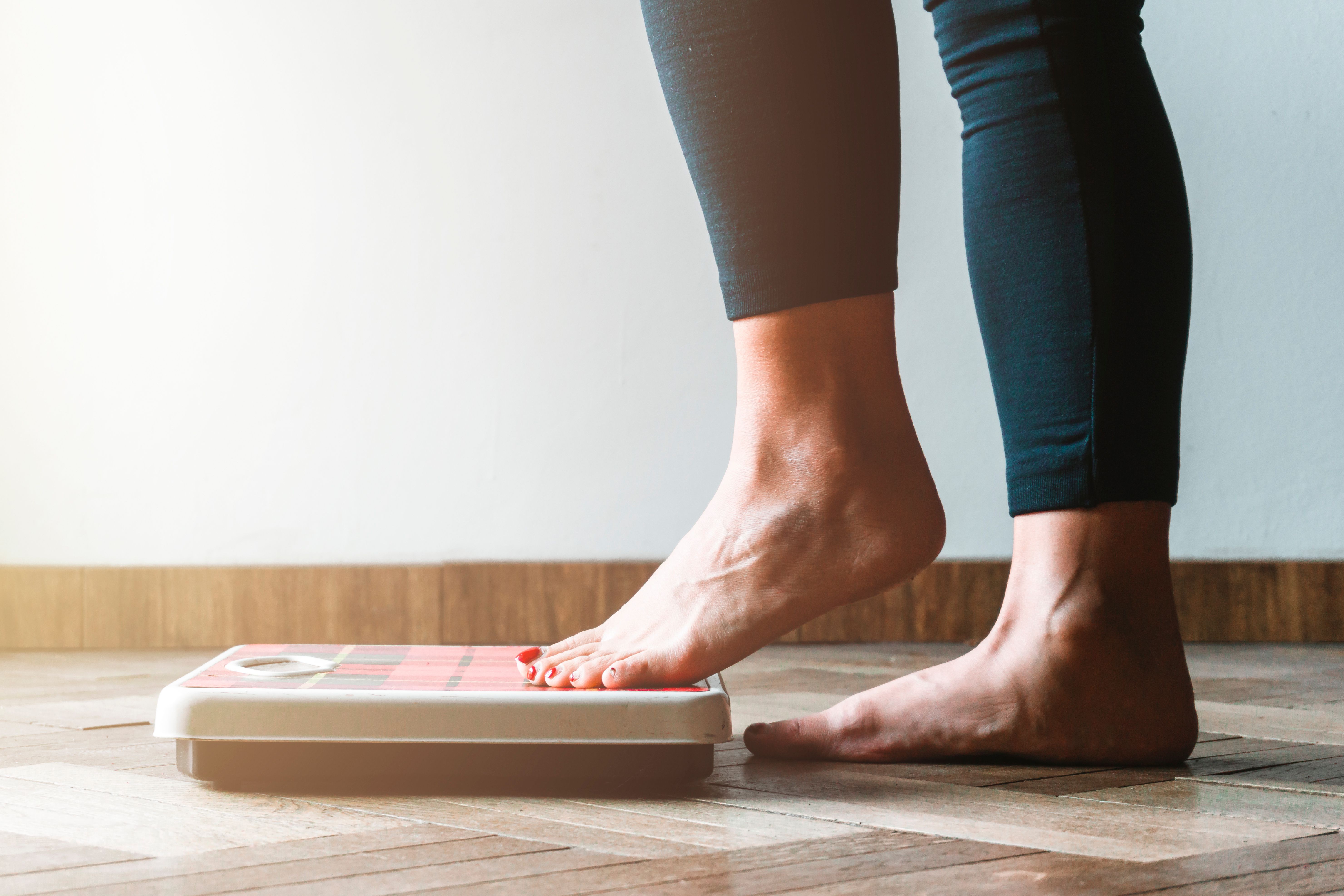 Woman stepping on a scale