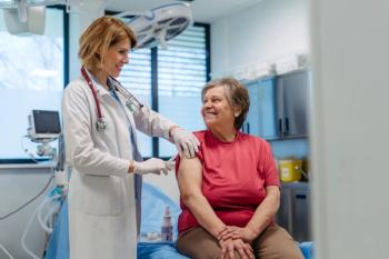 Elderly patient being vaccinated by doctor.