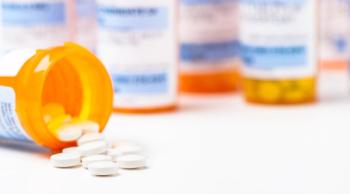 Round white prescription medication medicine pill tablets spilling from a bottle with numerous full bottles in background - Image credit: Eric Hood | stock.adobe.com