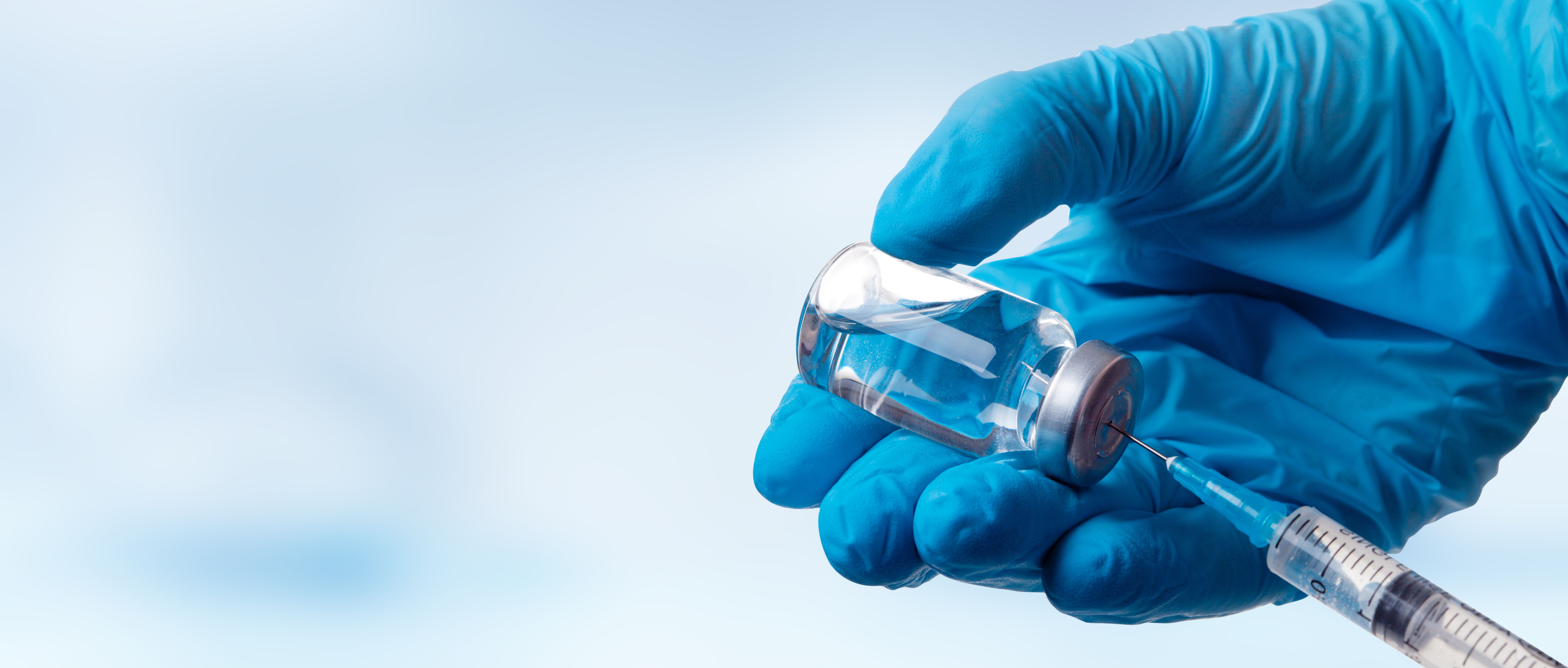 Hand holding viol with vaccine against corona virus - Image credit: Thaut Images | stock.adobe.com