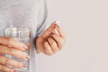 Patient taking mifepristone with water -- Image credit: doucefleur | stock.adobe.com