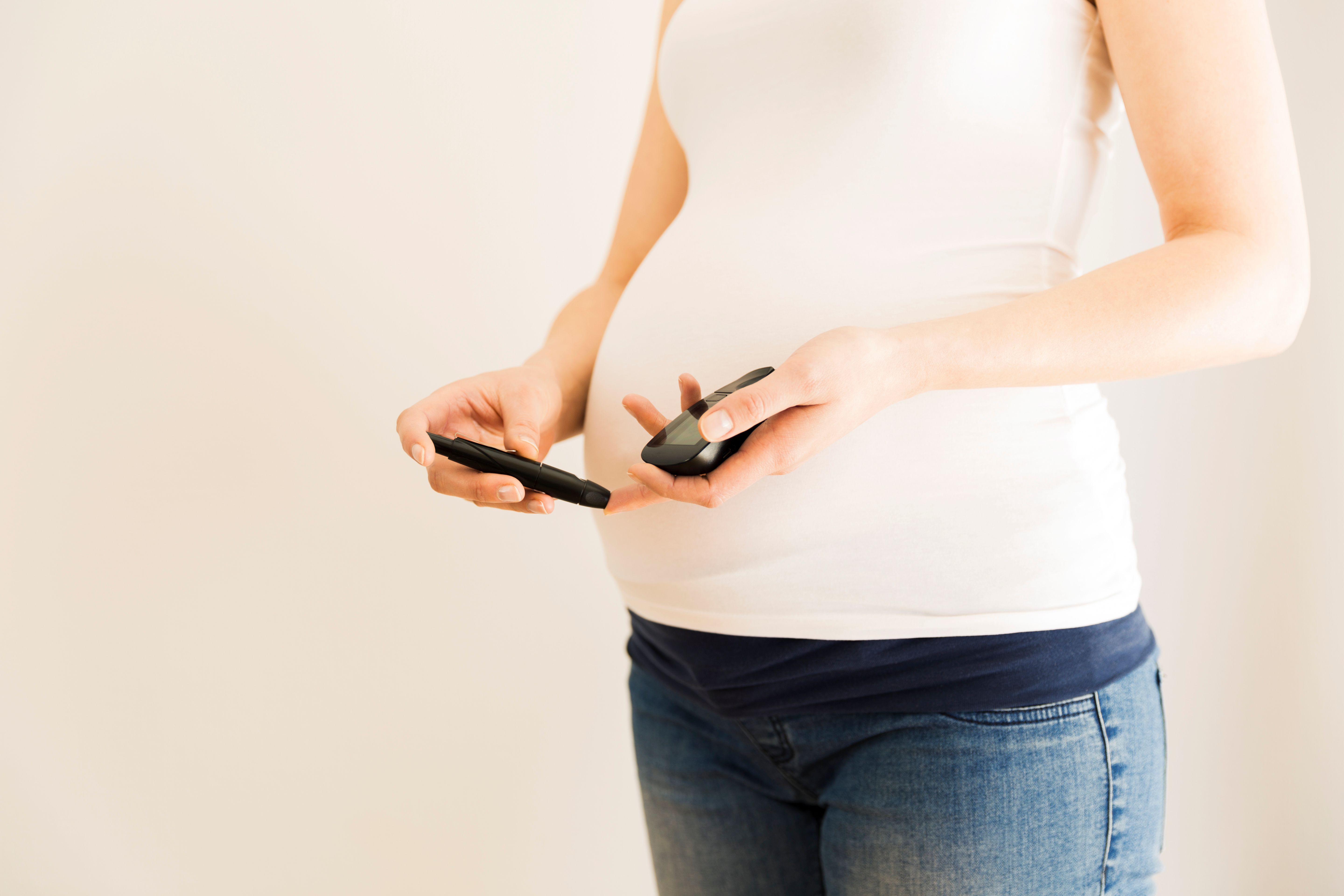 Pregnant woman checking blood sugar level. Gestational diabetes. Pregnancy health | Image credit: Artursfoto - stock.adobe.com