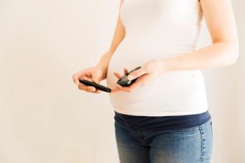 Pregnant woman checking blood sugar level. Gestational diabetes. Pregnancy health | Image credit: Artursfoto - stock.adobe.com