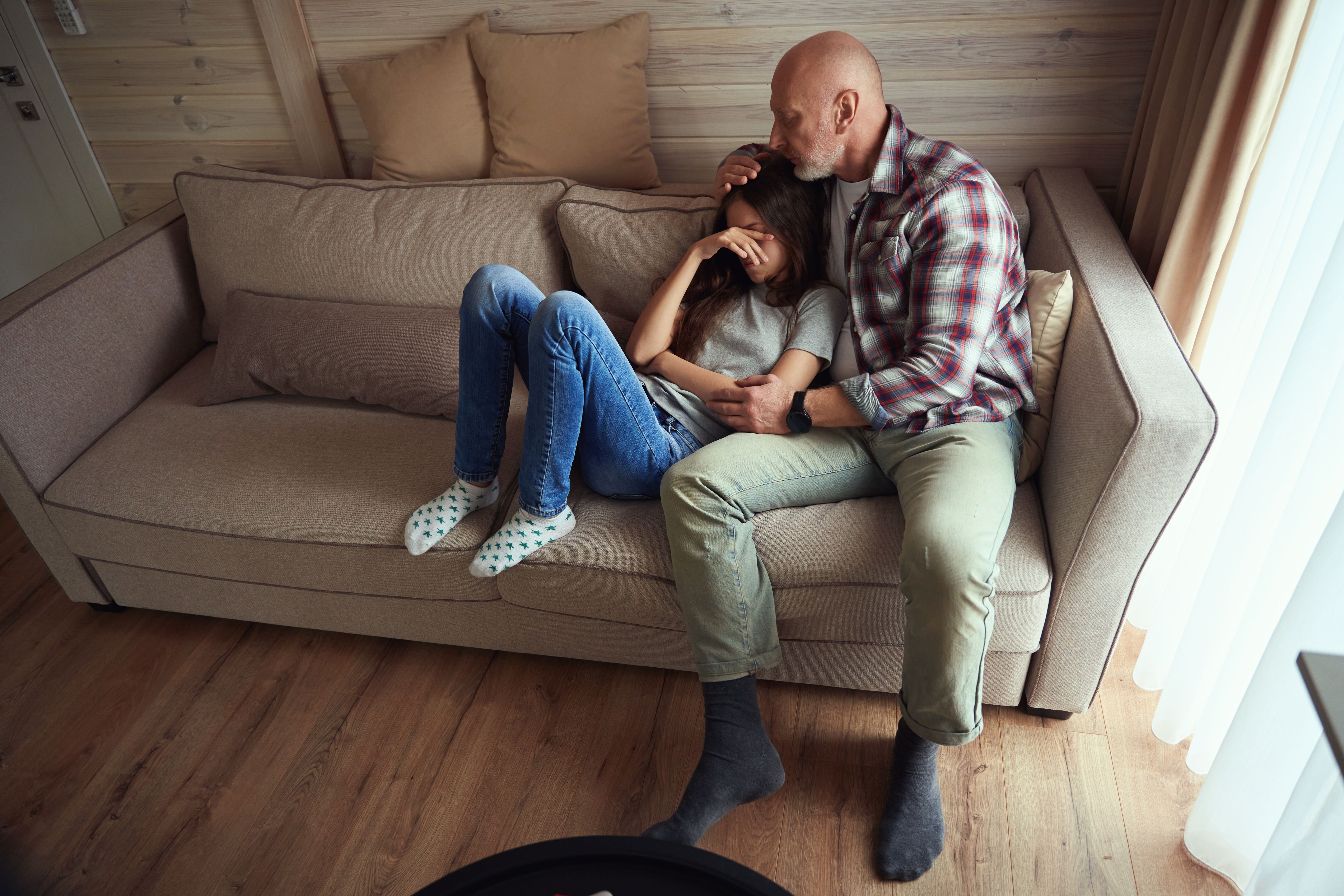 Caring parent comforting his despondent teenage daughter - Image credit: Svitlana | stock.adobe.com