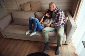Caring parent comforting his despondent teenage daughter - Image credit: Svitlana | stock.adobe.com