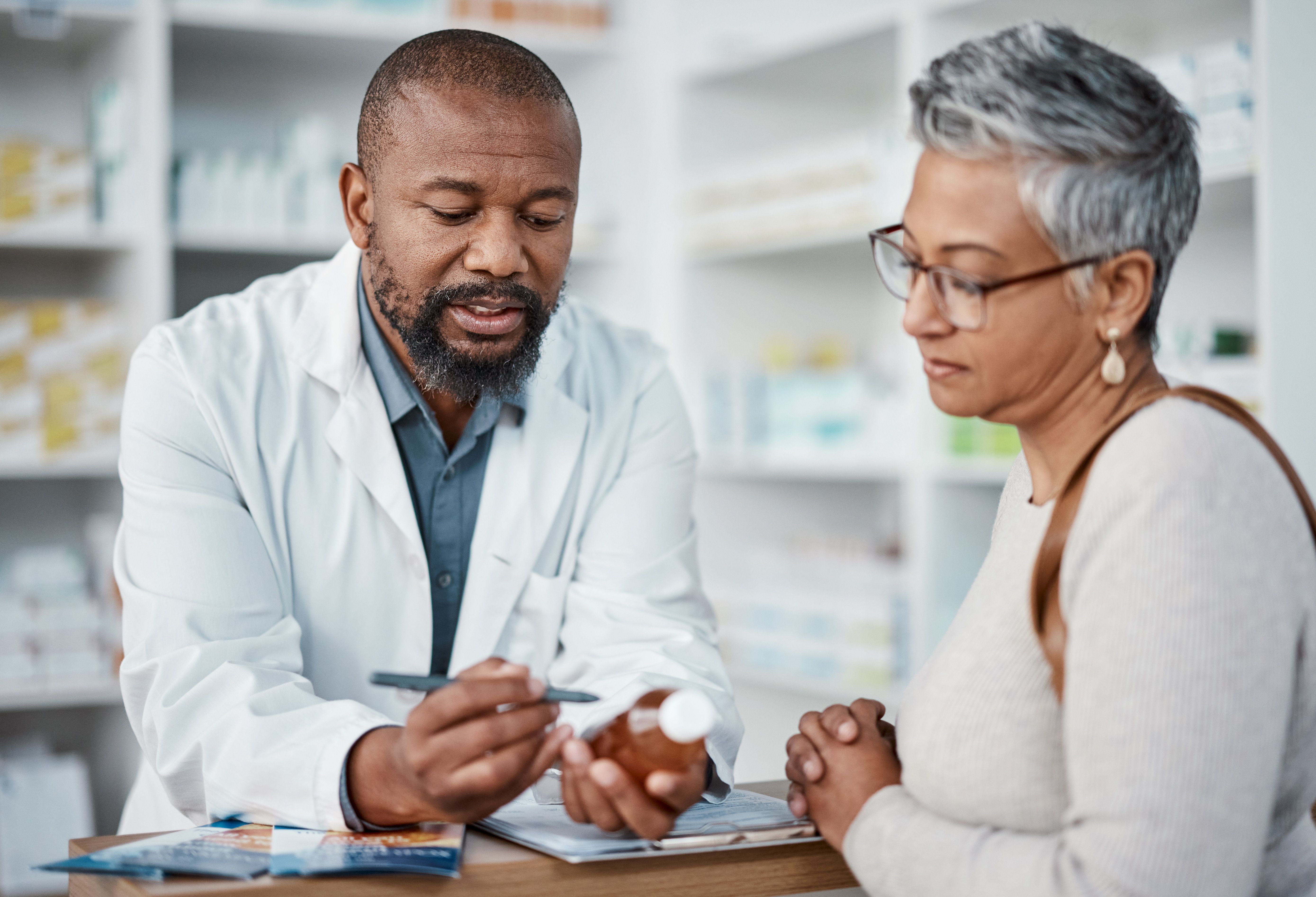 Pharmacist counseling a patient -- Image credit: Clayton D/peopleimages.com | stock.adobe.com