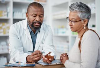 Pharmacist helping a patient with medication -- Image credit: Clayton D/peopleimages.com | stock.adobe.com