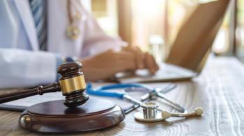 Close-up of the wooden gavel and stethoscope on desk with male doctor using a laptop. Concept of medical law and medical crimes - Image credit: inthasone | stock.adobe.com 