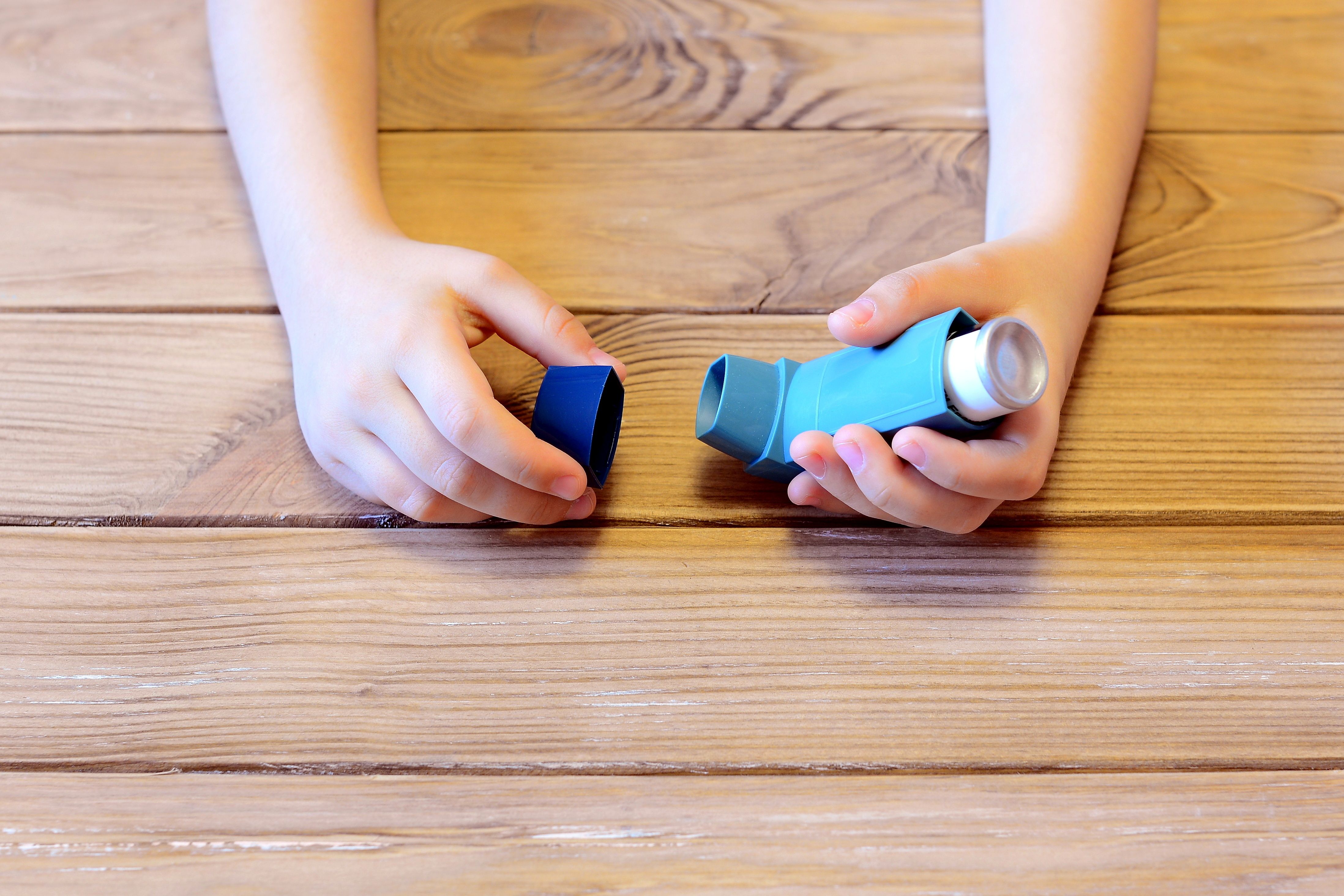 Child holding an asthma inhaler