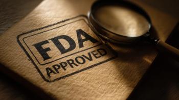 Document stamped with "FDA Approved" next to magnifying glass | Image Credit: © aznan - stock.adobe.com