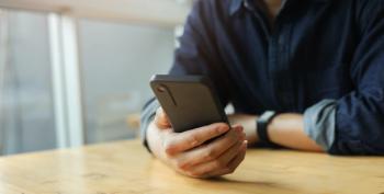 close up businessman hand hold smartphone to surfing the internet and check work or mail on website while sit in the living room in weekend for business technology and lifestyle concept