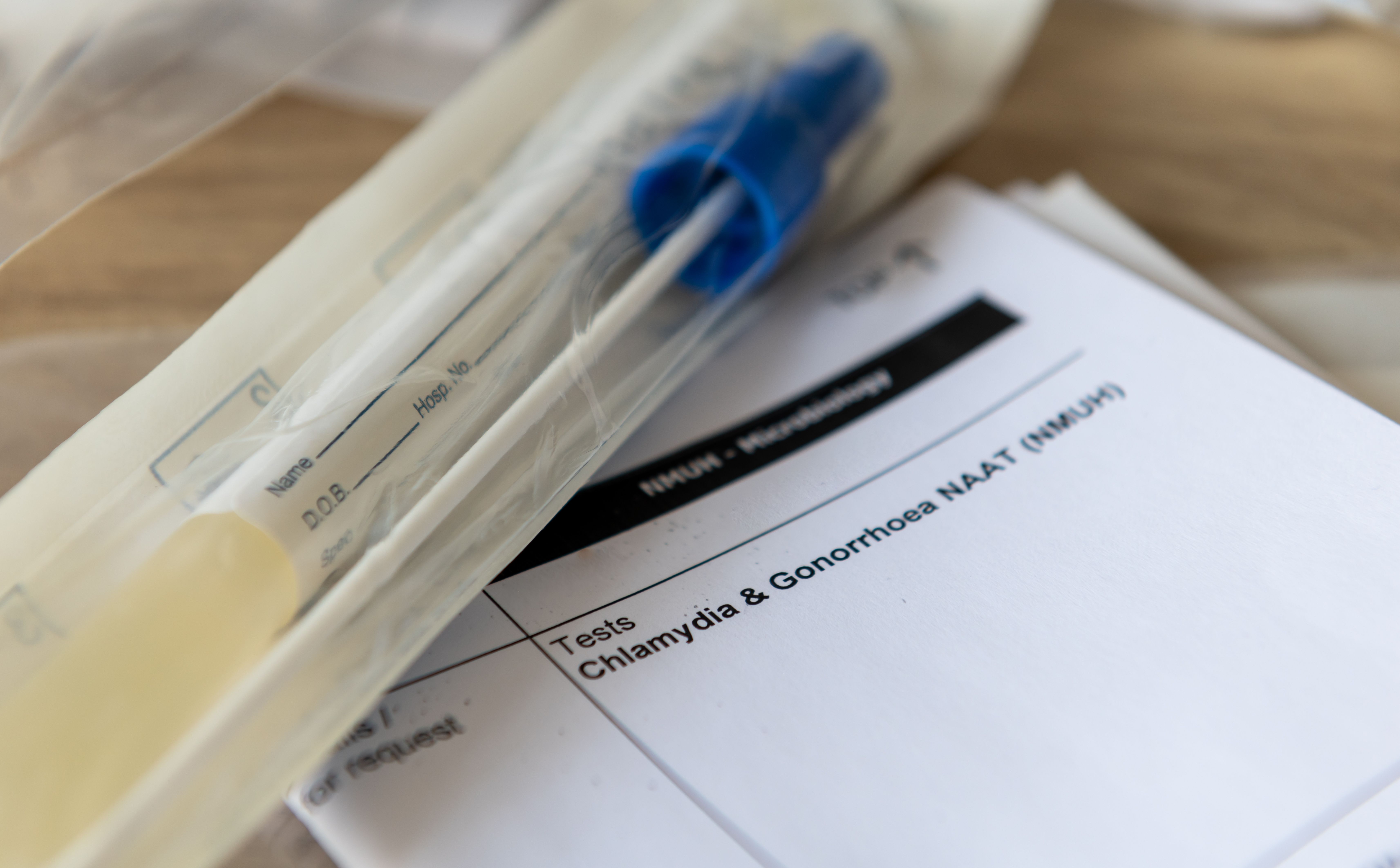 A sample container and medical form for a Chlamydia and Gonorrhoea test - Image credit: Ming | stock.adobe.com