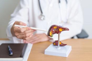 Physician pointing to a liver model