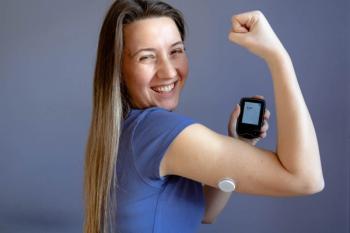 Woman smiling and showing her arm with a continuous glucose monitor for diabetes