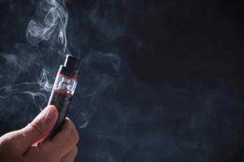 Electronic cogarette vape on a dark background with steam