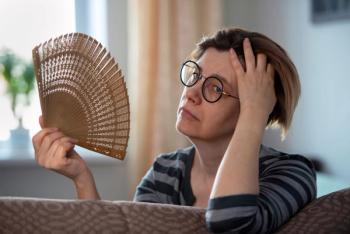 Menopausal woman having a hot flash -- Image credit: Zadvornov | stock.adobe.com