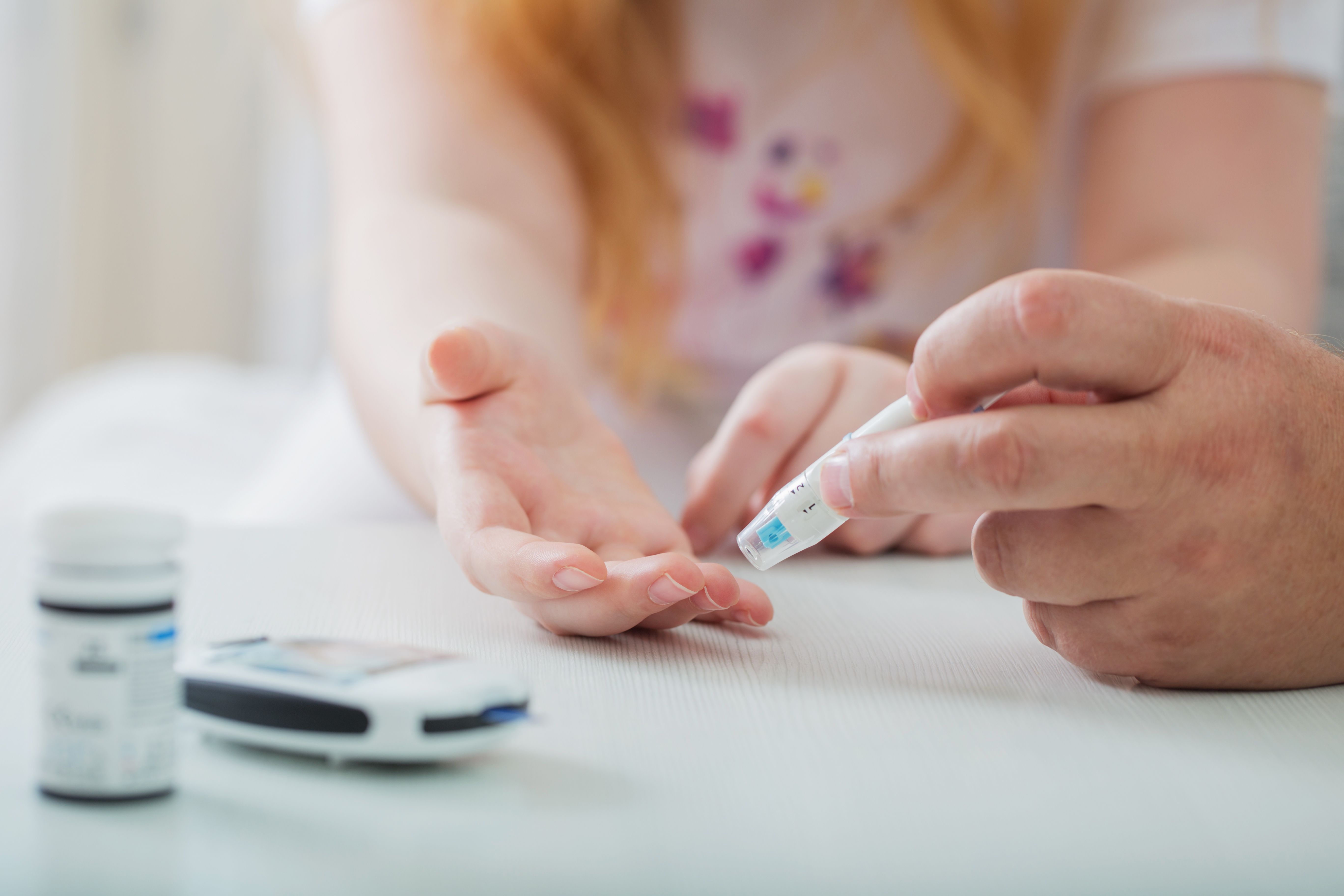 Measuring Blood Sugar Level Of Teen Girl With Glucometer - Image credit: Maya Kruchancova | stock.adobe.com