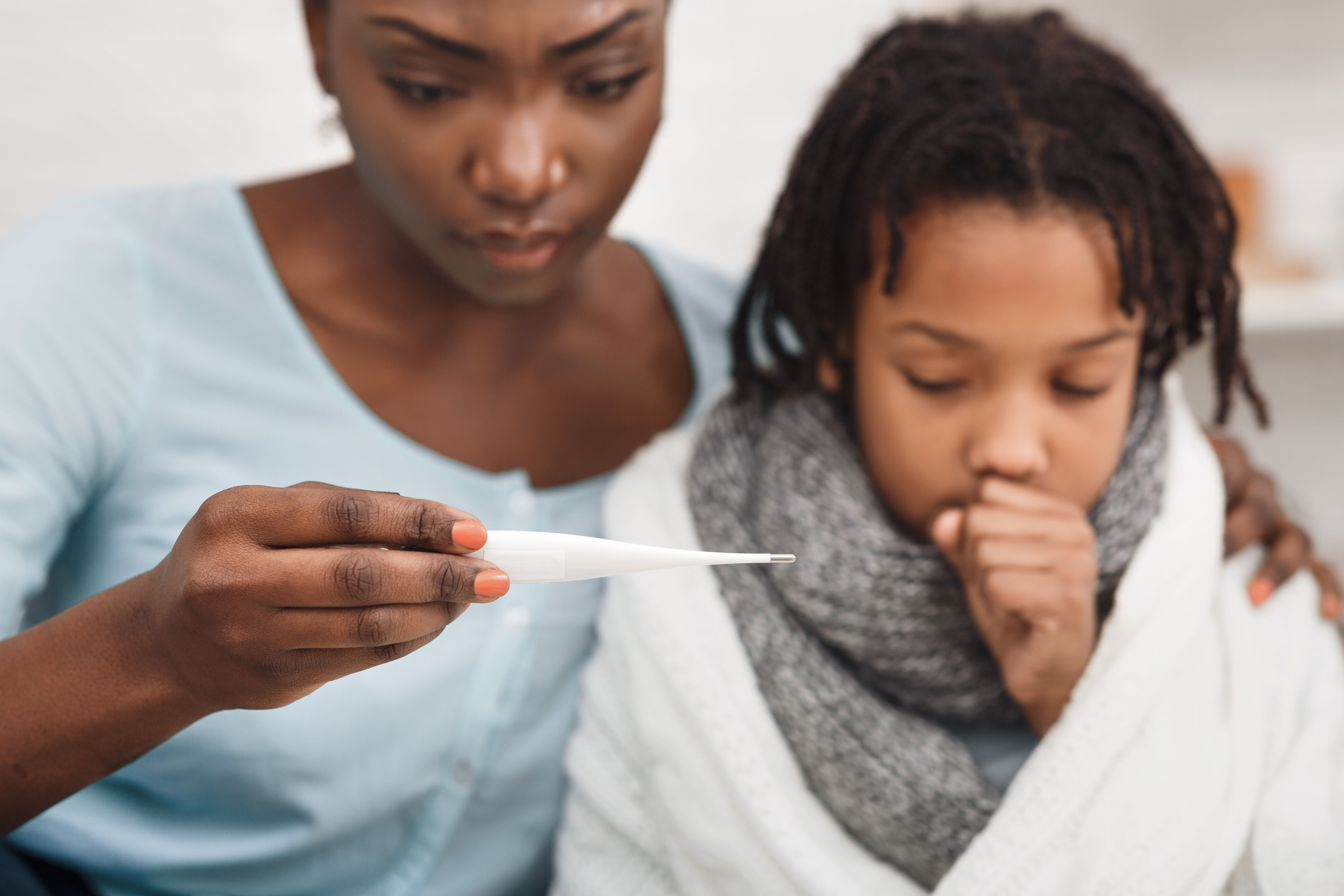 Close-up of afro woman with daughter having cold - Image credit: Prostock-studio | stock.adobe.com