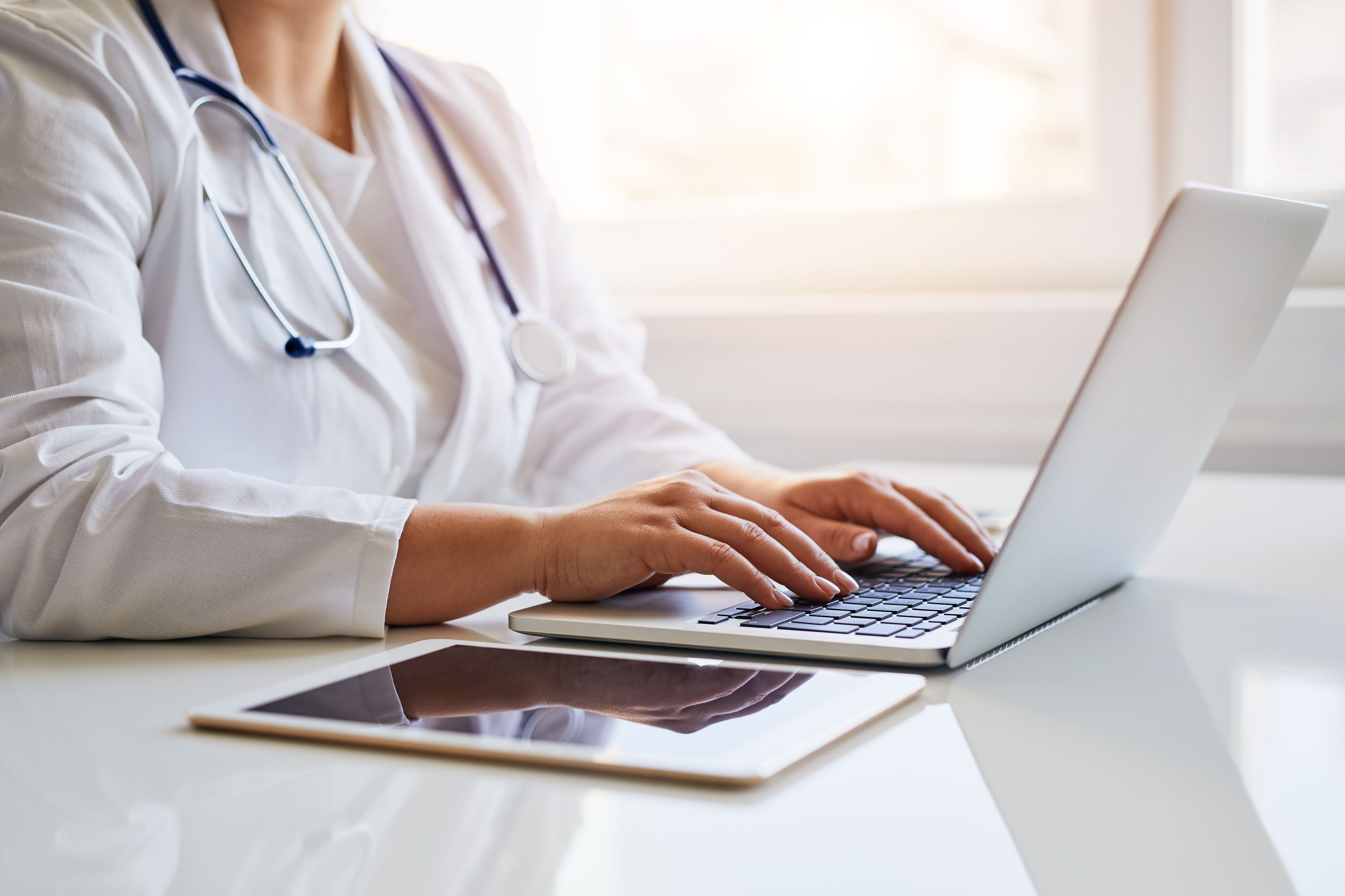 Health care professional on laptop -- Image credit: Rostislav Sedlacek | stock.adobe.com