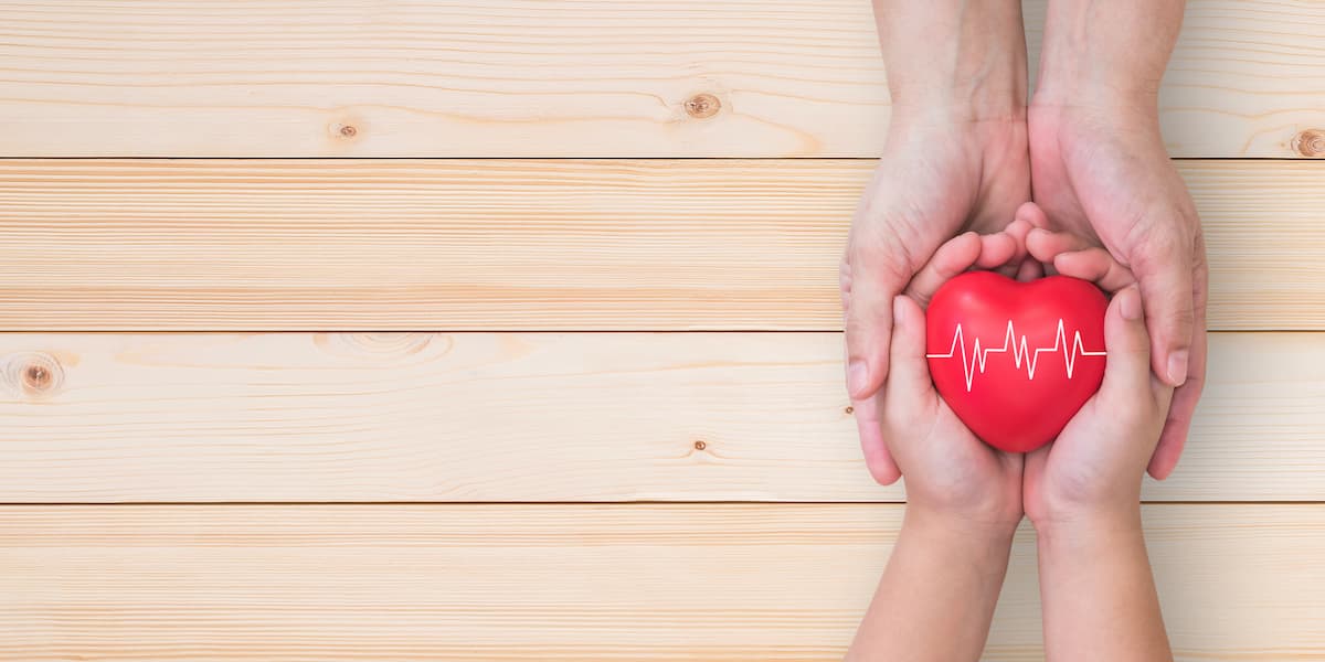 Life and health insurance, pediactric nursing care and childhood cardiovascular heart disease, healthcare concept with child and parent supporting heart with pulse sign 