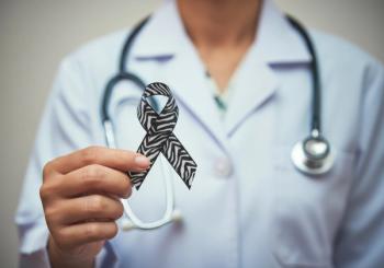 Health care professional holding ribbon with zebra-print pattern -- Image credit: Jenny | stock.adobe.com