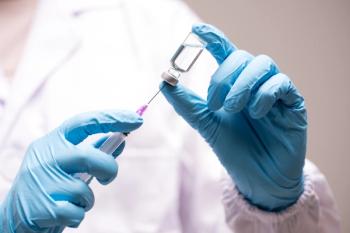 Doctor hand in blue gloves holding influenza vaccine for prevention human - Image credit: Arcyto | stock.adobe.com