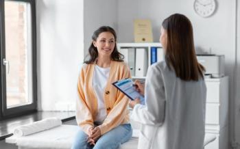 Medicine, healthcare and people concept - female doctor with clipboard talking to smiling woman patient at hospital - Image credit: Syda Productions | stock.adobe.com