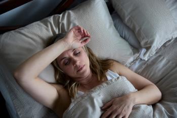 Menopausal woman having night sweats -- Image credit: highwaystarz | stock.adobe.com