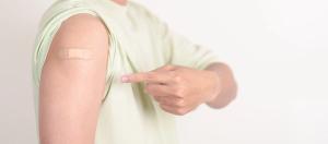 Adult Man with bandage after received vaccine. Vaccination and Immunization for Influenza, HPV, Zoster, IPD, DTP or Diphtheria, Tetanus and Pertussis, MMR, Hepatitis B, Covid and Varicella vaccine