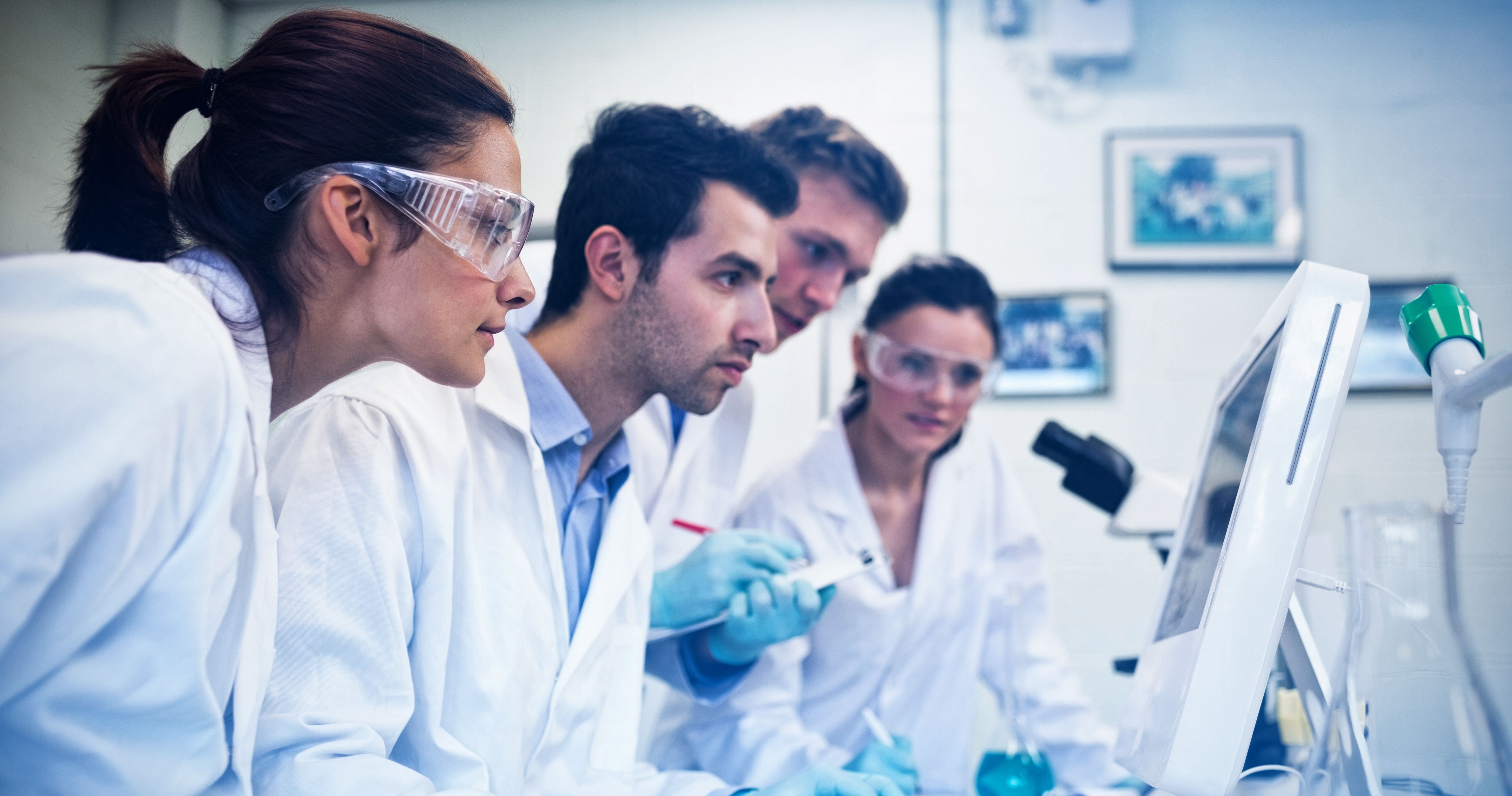 Serious researchers looking at computer screen in the lab | Image Credit: vectorfusionart - stock.adobe.com