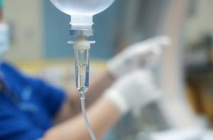 Health care worker preparing an IV drip -- Image credit: Pitchy | stock.adobe.com