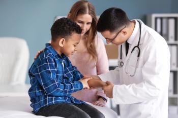 Pediatrician examining boy in clinic -- Image credit: Pixel-Shot | stock.adobe.com
