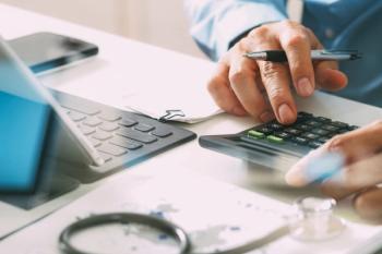 Pharmacist calculating health care costs -- Image credit: everythingpossible | stock.adobe.com