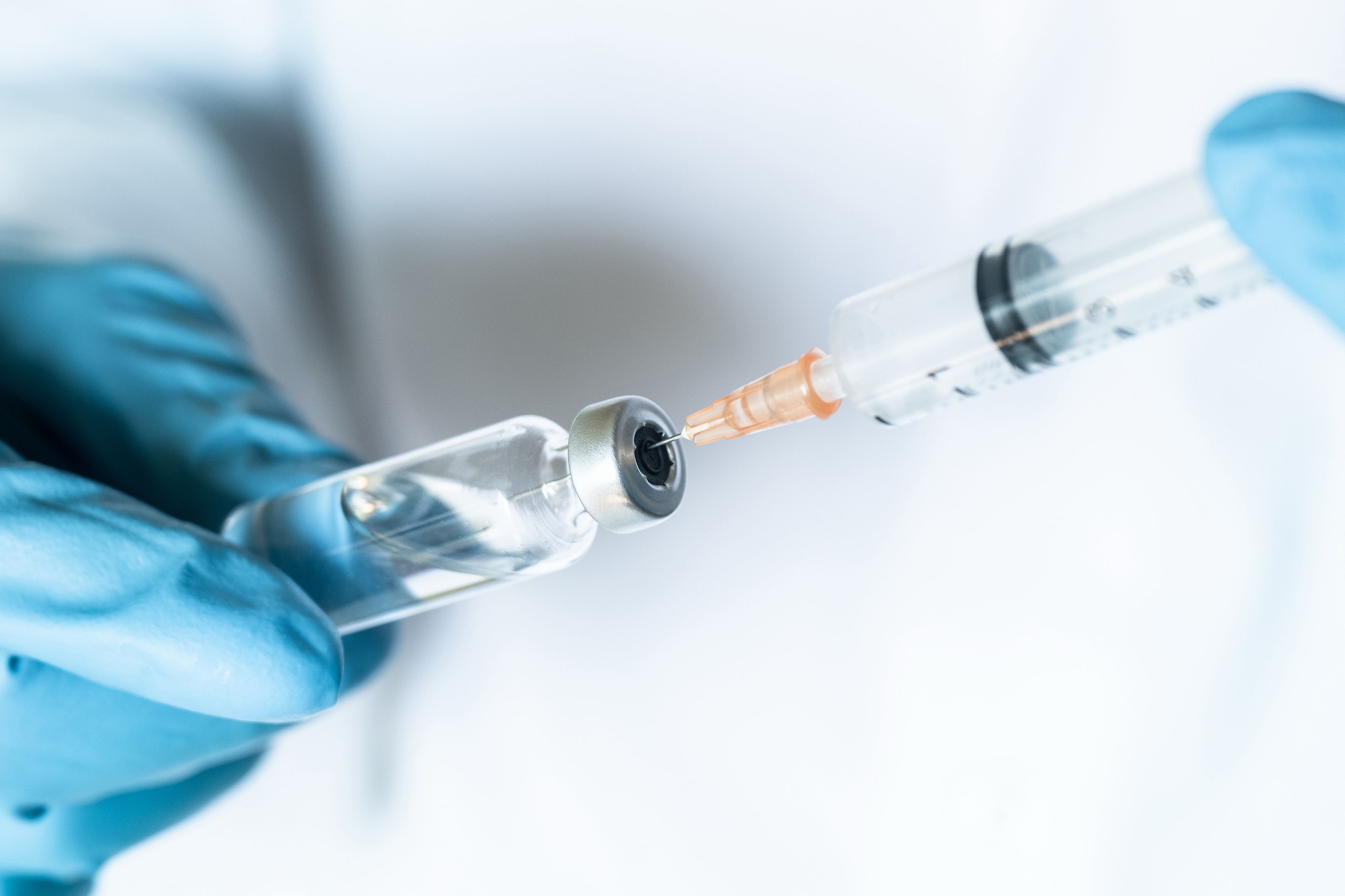 Health care worker administering vaccine