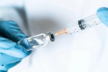 Health care worker administering vaccine