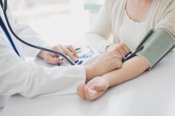 The doctor measures blood pressure to the patient