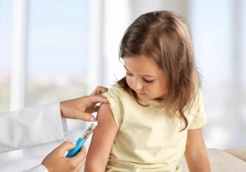 Female nurse giving an arm injection to a child. Little kid in getting a shot at a modern vaccination center. - Image credit: BillionPhotos.com | stock.adobe.com