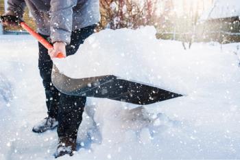 Man clearing snow by shovel after snowfall. Outdoors. | Image Credit: svetlana_cherruty - stock.adobe.com