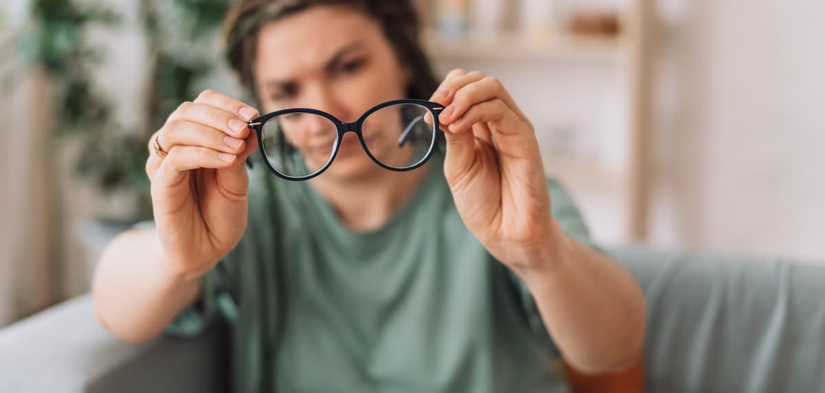 girl looks at the glasses checking for dirt.