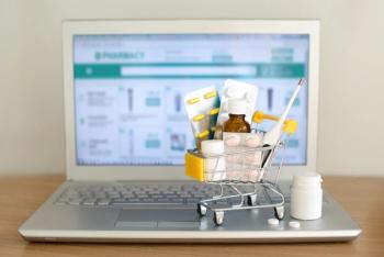Shopping cart toy with medicaments in front of laptop screen with pharmacy web site on it. Pills, blister packs, medical bottles, thermometer set. Health care and internet shopping. | Image Credit: evso | stock.adobe.com