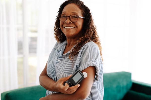 Senior woman using a flash glucose monitor to manage her diabetes at home - Image credit: (JLco) Julia Amaral | stock.adobe.com