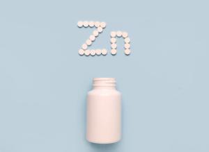 Chemical element Zinc Zn icon from tablets and drug bottle on blue background. Colltction of vitamin and minerals - Image credit: Iryna | stock.adobe.com