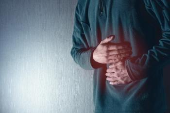 Man holds his belly with both hands. Stomach ache. Gastritis. Blue grey background - Image credit: Fotografie-Schmidt | stock.adobe.com